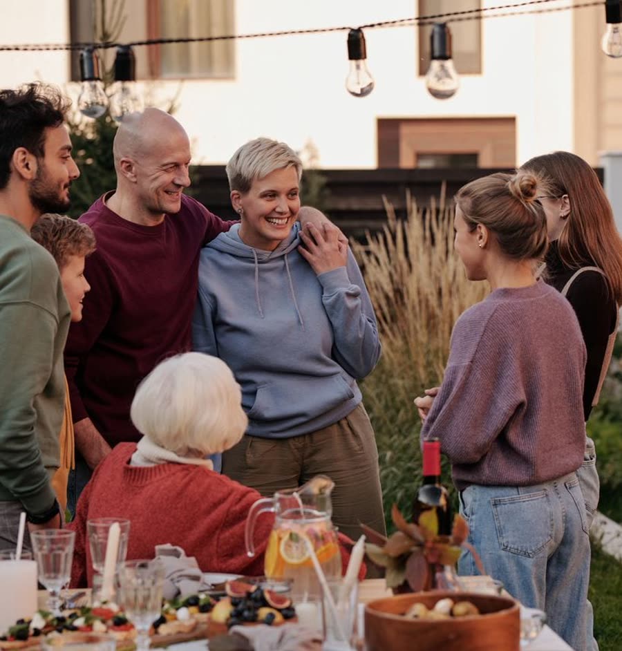 Several generations of a family around a table in the garden